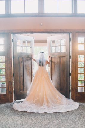 Phoenix wedding photography of bride’s dress in doorway