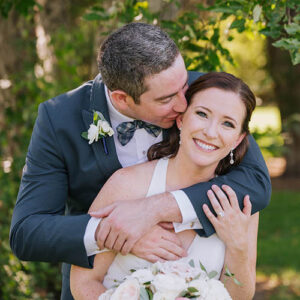 Groom kisses his bride by Denver wedding photographers, Wanderlight
