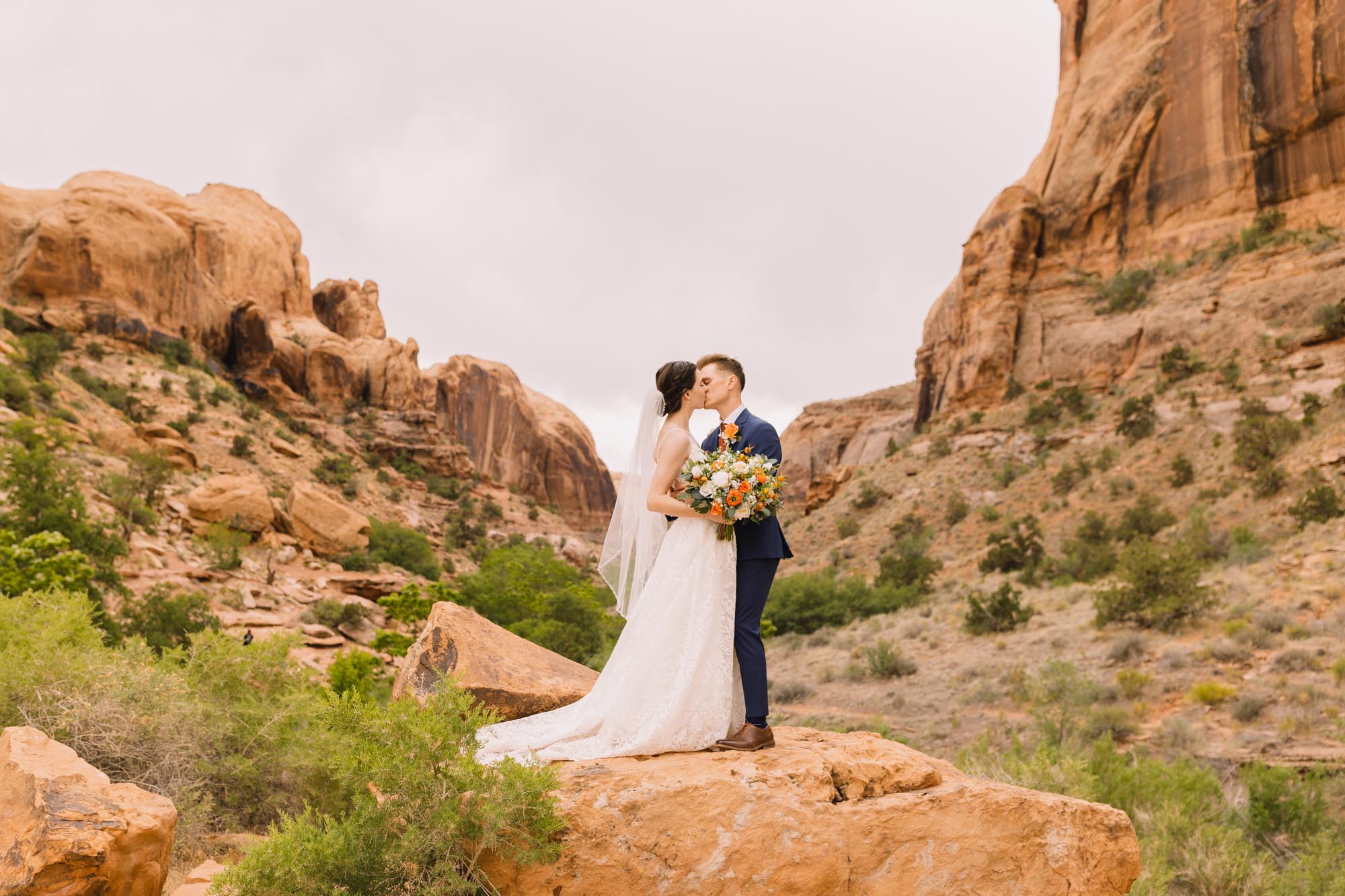 Bride and groom kiss in Arches National Park by Wanderlight, a Salt Lake City wedding photography company